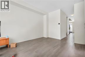 Thorold apartment for rent - A room with a wooden floor and white walls, with a door on the right side.