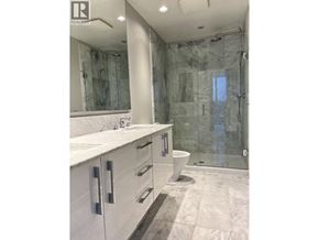 Vancouver apartment for rent - A bathroom with a marble shower and sink.