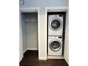 Vancouver apartment for rent - A washing machine is sitting in a small laundry room.