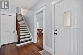 Erin apartment for rent - A hallway with a staircase and a door.