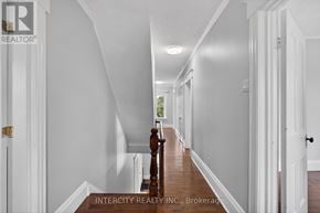 Erin apartment for rent - A hallway with white walls and a wooden floor.
