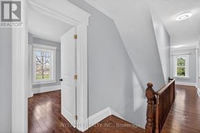 Erin apartment for rent - A white door is open to a hallway with wood floors and white walls.