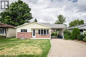 Kitchener apartment for rent - A house with a brick pathway leading to the front door.