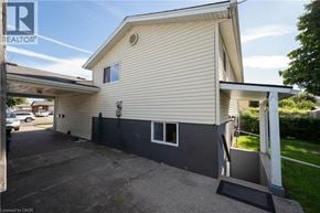Kitchener apartment for rent - A house with a beige siding and a grey roof with a white trim.