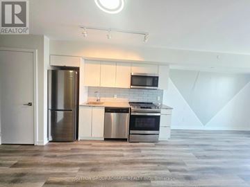 Toronto (O'connor-Parkview) condo for rent - A modern kitchen with a refrigerator, stove, and microwave.