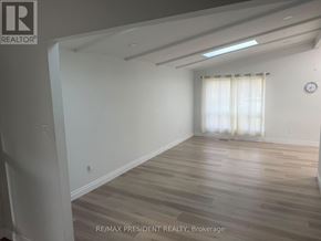 Toronto (West Humber-Clairville) apartment for rent - A room with wooden flooring and a window with curtains.