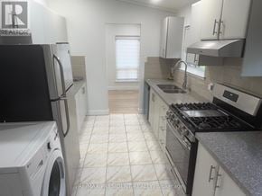 Toronto (West Humber-Clairville) apartment for rent - A modern kitchen with a washing machine and a refrigerator.