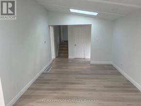 Toronto (West Humber-Clairville) apartment for rent - A room with wooden flooring and a white door.