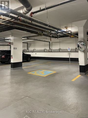 Toronto (Bayview Village) condo for rent - A parking garage with a yellow square on the floor.