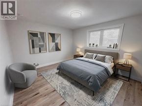 Kitchener apartment for rent - A bedroom with a bed, chair, and two lamps.