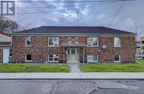 Toronto (Danforth Village-East York) apartment for rent - A brick house with a sign that says HomeLemision Realty Inc. Brokers.