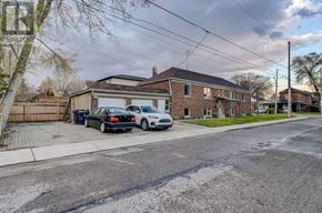 Toronto (Danforth Village-East York) apartment for rent - A black car is parked in front of a house.