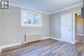 Toronto (Danforth Village-East York) apartment for rent - A room with a window, a door, and a radiator.