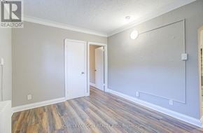 Toronto (Danforth Village-East York) apartment for rent - A room with a white door and a light on the wall.