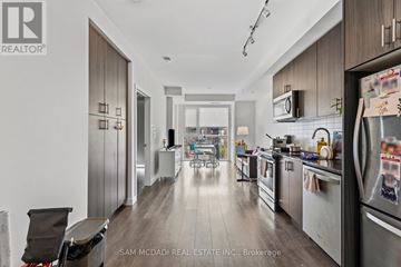 Oakville (Go Glenorchy) condo for rent - A modern kitchen with a refrigerator on the right side.