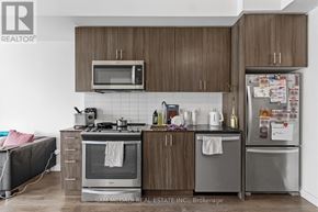 Oakville (Go Glenorchy) condo for rent - A kitchen with a microwave, oven, and refrigerator.