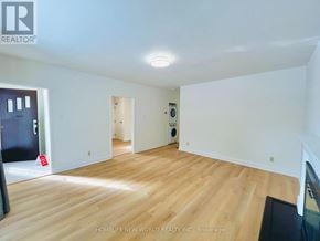 Toronto (Willowdale East) apartment for rent - A spacious room with wooden flooring and white walls.