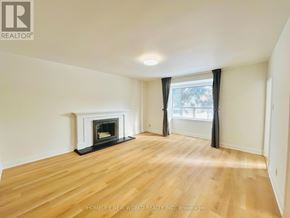 Toronto (Willowdale East) apartment for rent - A room with a fireplace and wooden flooring.