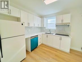 Toronto (Willowdale East) apartment for rent - A kitchen with white cabinets and a white fridge.