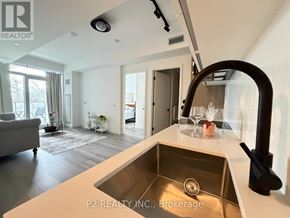 Toronto (Centennial Scarborough) condo for rent - A modern kitchen with a sink and a large window.