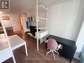 Toronto (Bay Street Corridor) condo for rent - A room with a desk, chair, and shelves.