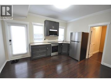 Vancouver apartment for rent - A kitchen with a refrigerator, stove, and cabinets.