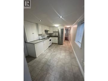 Vancouver apartment for rent - A kitchen with white cabinets and tile flooring.