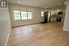Guelph/Eramosa (Rockwood) fourplex for rent - A room with wooden flooring and a window.