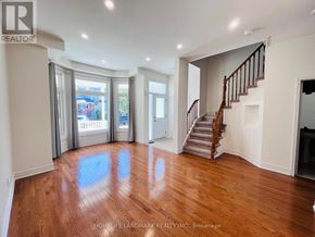 Markham (Cornell) apartment for rent - A spacious room with wooden floors and a staircase.