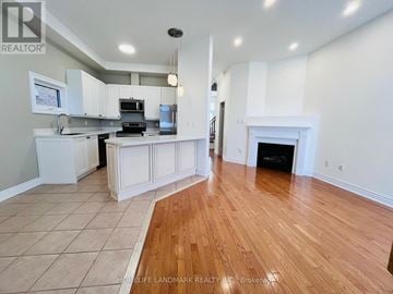 Markham (Cornell) apartment for rent - A spacious kitchen with white cabinets and a wood floor.