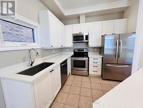 Markham (Cornell) apartment for rent - A kitchen with white cabinets and a stainless steel refrigerator.