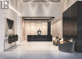Toronto (Waterfront Communities) condo for rent - A modern office lobby with a reception desk and a person standing behind it.