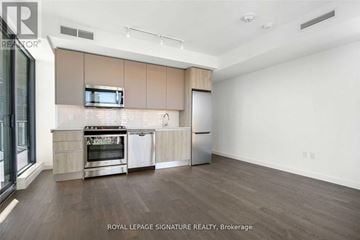 Toronto (Waterfront Communities) condo for rent - A kitchen with a stove top oven and a microwave above it.