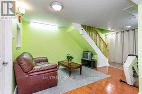 Toronto (Pleasant View) apartment for rent - A living room with a brown leather chair and a wooden coffee table.