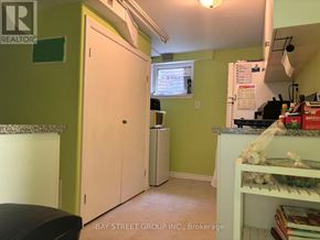 Toronto (Pleasant View) apartment for rent - A kitchen with green walls and a white fridge.
