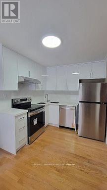 Whitby (Taunton North) apartment for rent - A kitchen with white cabinets and a wooden floor.