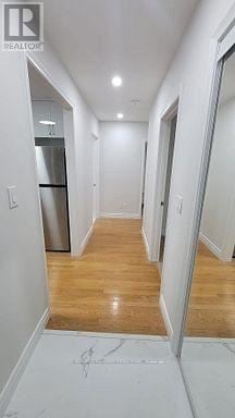 Whitby (Taunton North) apartment for rent - A hallway with a wooden floor and white walls.