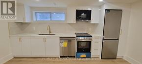 Aurora (Aurora Highlands) apartment for rent - A kitchen with white cabinets and a stainless steel refrigerator.
