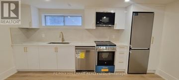 Aurora (Aurora Highlands) apartment for rent - A kitchen with white cabinets and a stainless steel refrigerator.