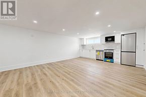 Aurora (Aurora Highlands) apartment for rent - A white kitchen with a refrigerator, microwave, and oven.