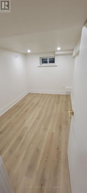Aurora (Aurora Highlands) apartment for rent - A room with wooden flooring and white walls.