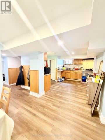 Mississauga (Cooksville) apartment for rent - A kitchen with wooden floors and a dining area with a table and chairs.