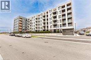 Milton condo for rent - A modern apartment building with cars parked in front.