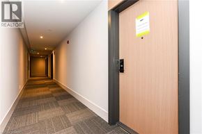 Milton condo for rent - A hallway with a door on the right and a sign on the door.