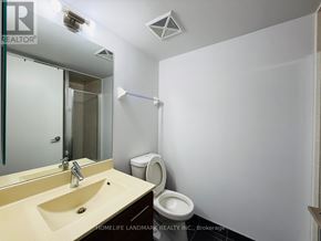 Toronto (Agincourt South-Malvern West) condo for rent - A bathroom with a sink, mirror, toilet and a white wall.
