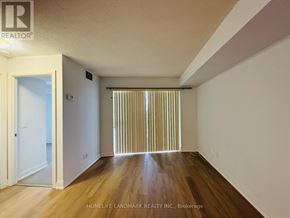 Toronto (Agincourt South-Malvern West) condo for rent - A room with wooden floors and a window with blinds.