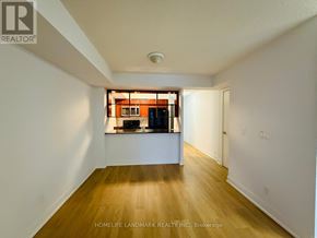 Toronto (Agincourt South-Malvern West) condo for rent - A room with wooden floors and white walls, with a window and a door visible.