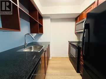 Toronto (Agincourt South-Malvern West) condo for rent - A kitchen with dark brown cabinets and a black countertop.