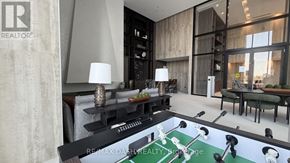Vaughan (Steeles West Industrial) condo for rent - A modern living room with a pool table in the center.