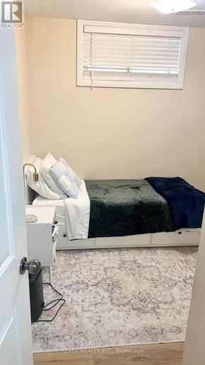 Toronto (Keelesdale-Eglinton West) apartment for rent - A bedroom with a bed, pillows, and a rug.